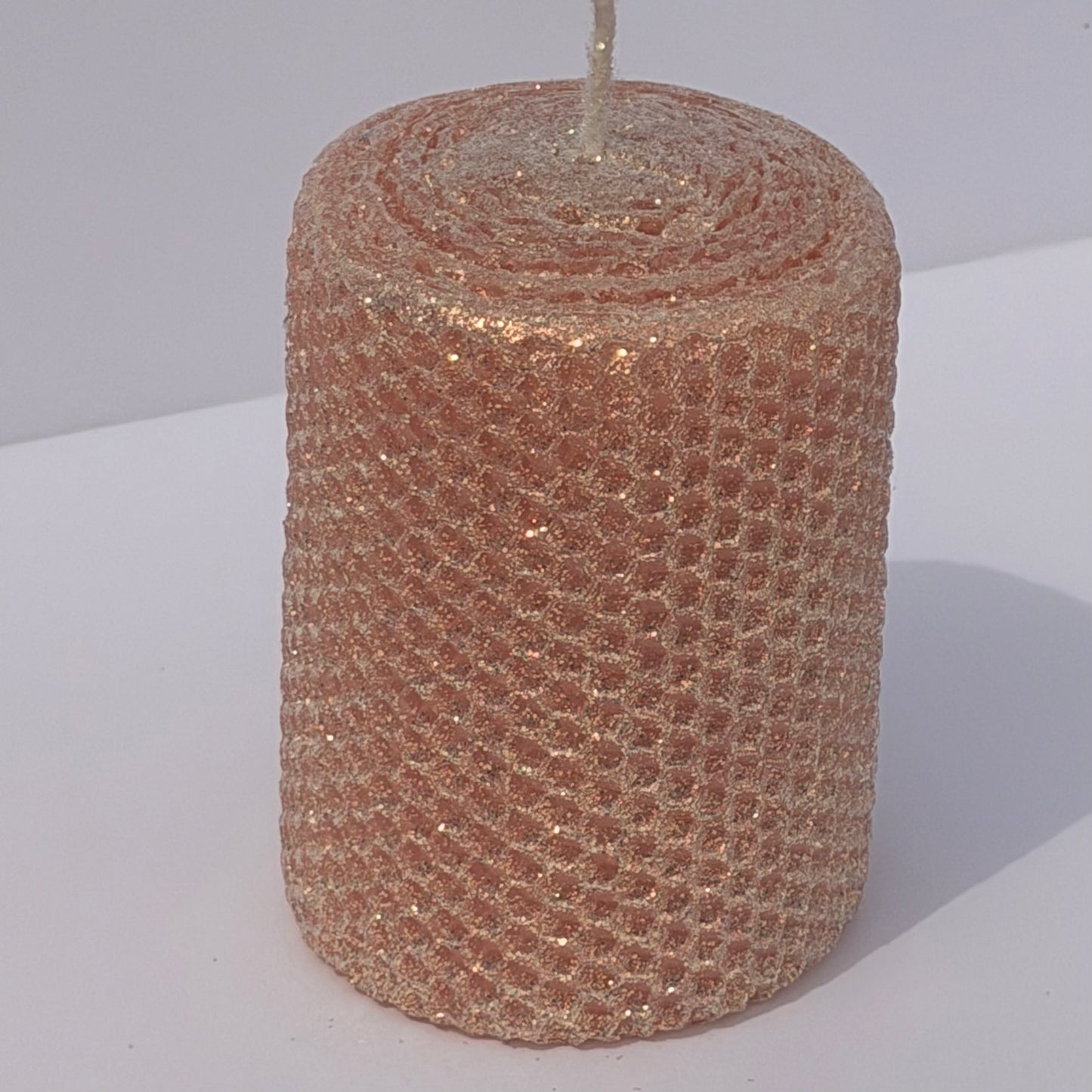 Our Blush Limited Edition candle is a delicate whisper of romance. Hand-rolled from pure beeswax it glows in a soft blush pink, with a subtle beige undertone. Dusted with our classic iridescent glitter, it catches the light with a gentle gold shimmer, adding a touch of timeless elegance to any space.