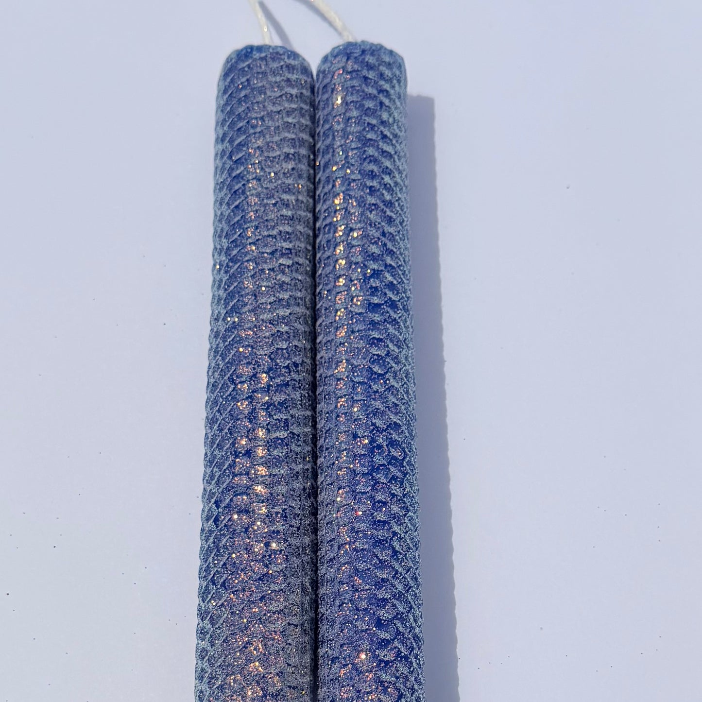 Our bright blue classic glitter candle dazzles with a vivid sapphire hue, wrapped in an opalescent glitter that glows with a golden undertone-infusing your space with a bold, energetic radiance and a sparkling, modern charm.
