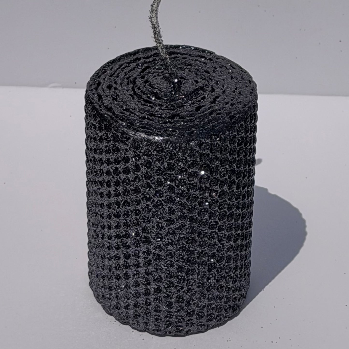 Add a touch of modern elegance with our Graphite Metallic Glitter Pillar Candles. Inspired by the sleek depth of pencil lead, these candles are a rich graphite gray, coated in a dazzling metallic glitter that catches the light and enhances every subtle curve. Perfect for adding a refined, luminous accent to any dinner or special event.