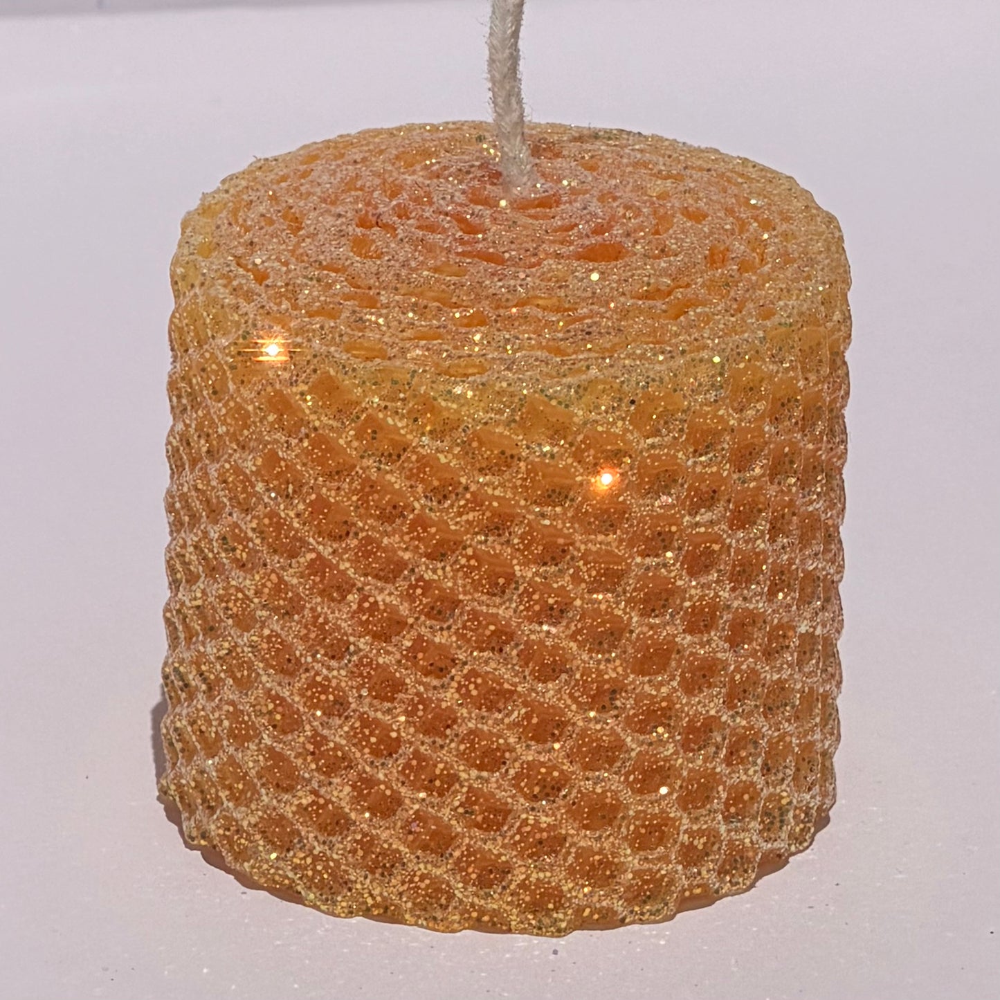 Celebrate the lightness of spring and summer with our Apricot Limited Edition Candle. Hand-rolled from natural beeswax in a soft, pale orange, this candle is adorned with a delicate dusting of our classic iridescent glitter with a golden undertone. Natural and elegant, it brings a subtle shimmer and a serene glow to any evening or event.