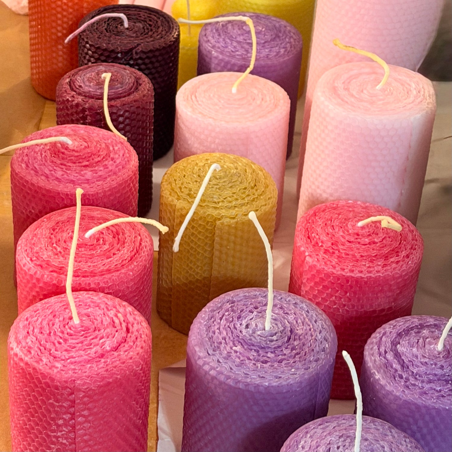 Our natural, unglittered, candles are made from 100% beeswax sheets and offered in a variety of colors all with the traditional honeycomb design to add to the beauty of the beeswax. Our candles are handmade, rolled by hand and made to order.