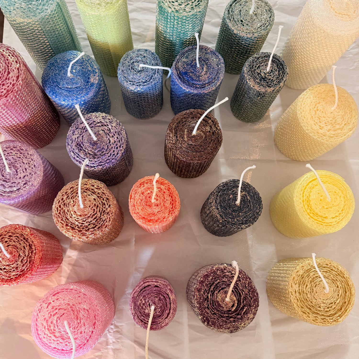 Also called our “Sugared” line… The wax color underneath shows through a dusting of opalescent glitter with a gold undertone. . . Giving the candles a sugar plum type look with a lovely golden hue. Our candles are handmade, hand rolled made to order.