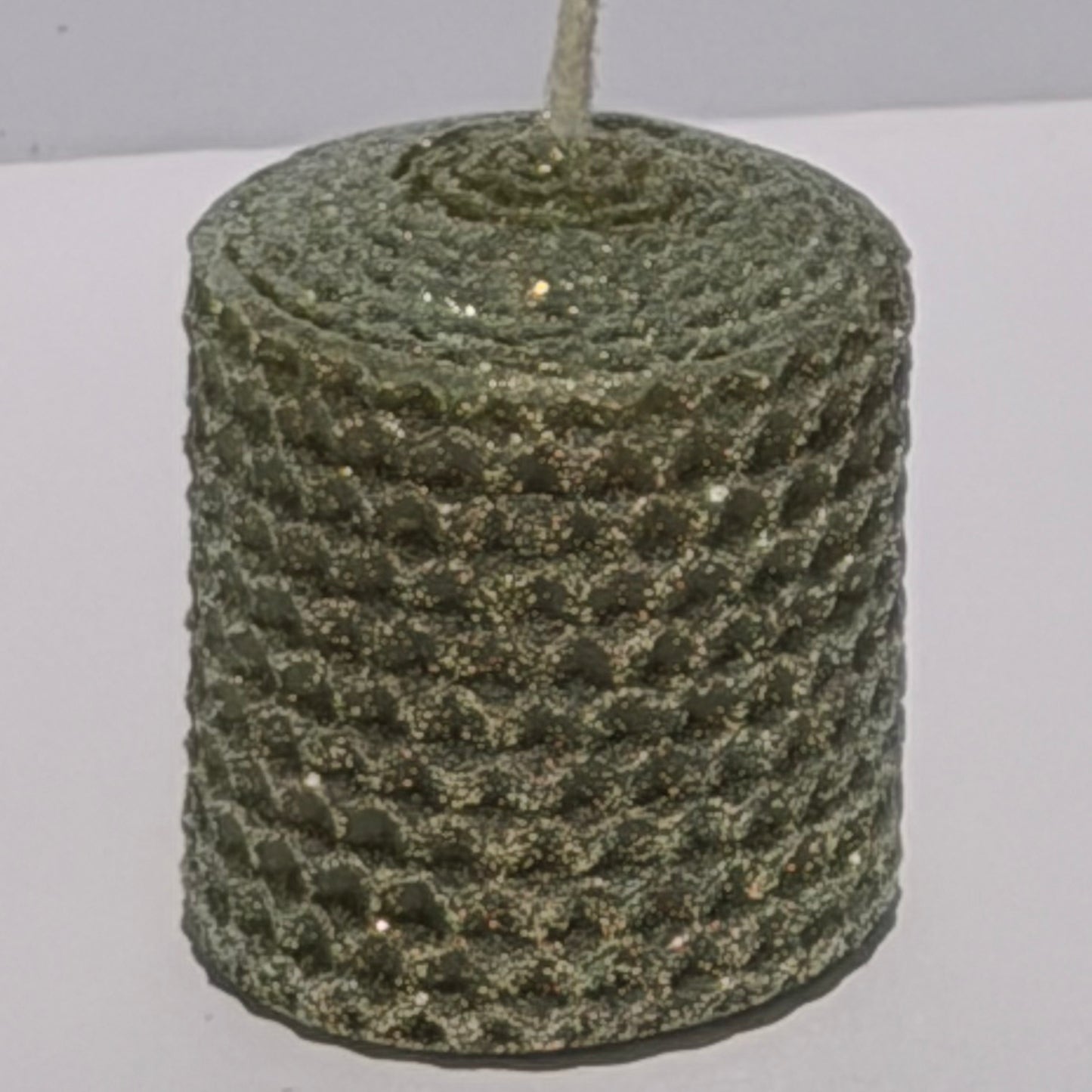 Our Olive Limited Edition candle features a rich, muted green, softly dusted with our classic opalescent glitter with a golden undertone-allowing the natural depth of the wax to glow through with a subtle, luminous shimmer. This exclusive hue brings a refined, earthy elegance with a fleeting touch of sparkle.