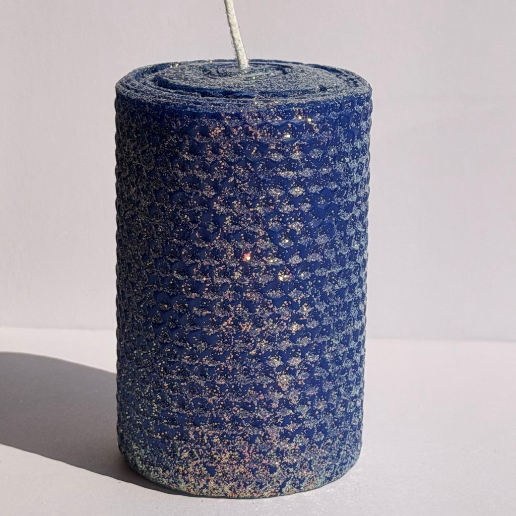 Our bright blue classic glitter candle dazzles with a vivid sapphire hue, wrapped in an opalescent glitter that glows with a golden undertone-infusing your space with a bold, energetic radiance and a sparkling, modern charm.