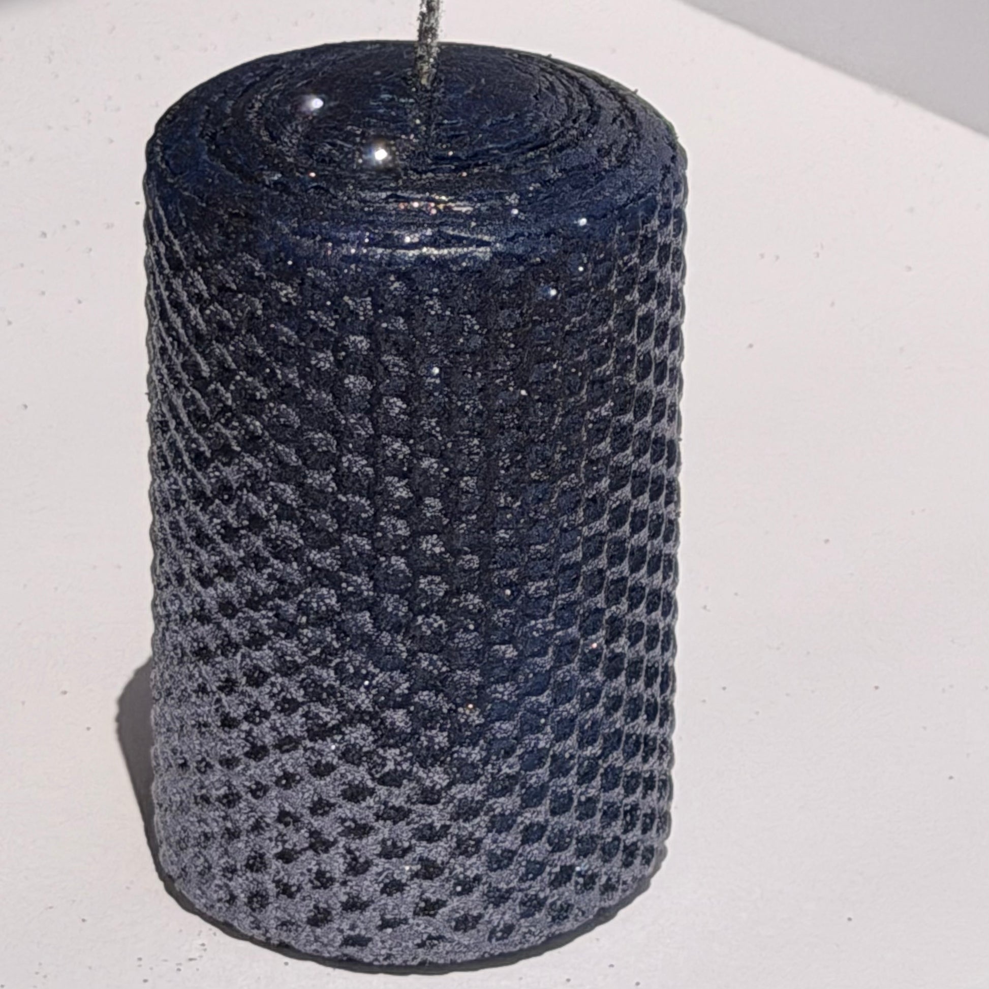 Illuminate your space with the regal beauty of our Black Sapphire Specialty Candle. Hand-rolled from our Bright Blue beeswax, each candle is adorned with a dusting of graphite metallic glitter, allowing the deep sapphire glow to shine through. With every flicker, it captures a bold, captivating elegance, perfect for special occasions or a touch of nighttime charm.