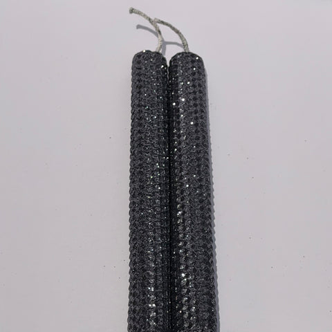 Add a touch of modern elegance with our Graphite Metallic Glitter Taper Candles. Inspired by the sleek depth of pencil lead, these candles are a rich graphite gray, coated in a dazzling metallic glitter that catches the light and enhances every subtle curve. Perfect for adding a refined, luminous accent to any dinner or special event.