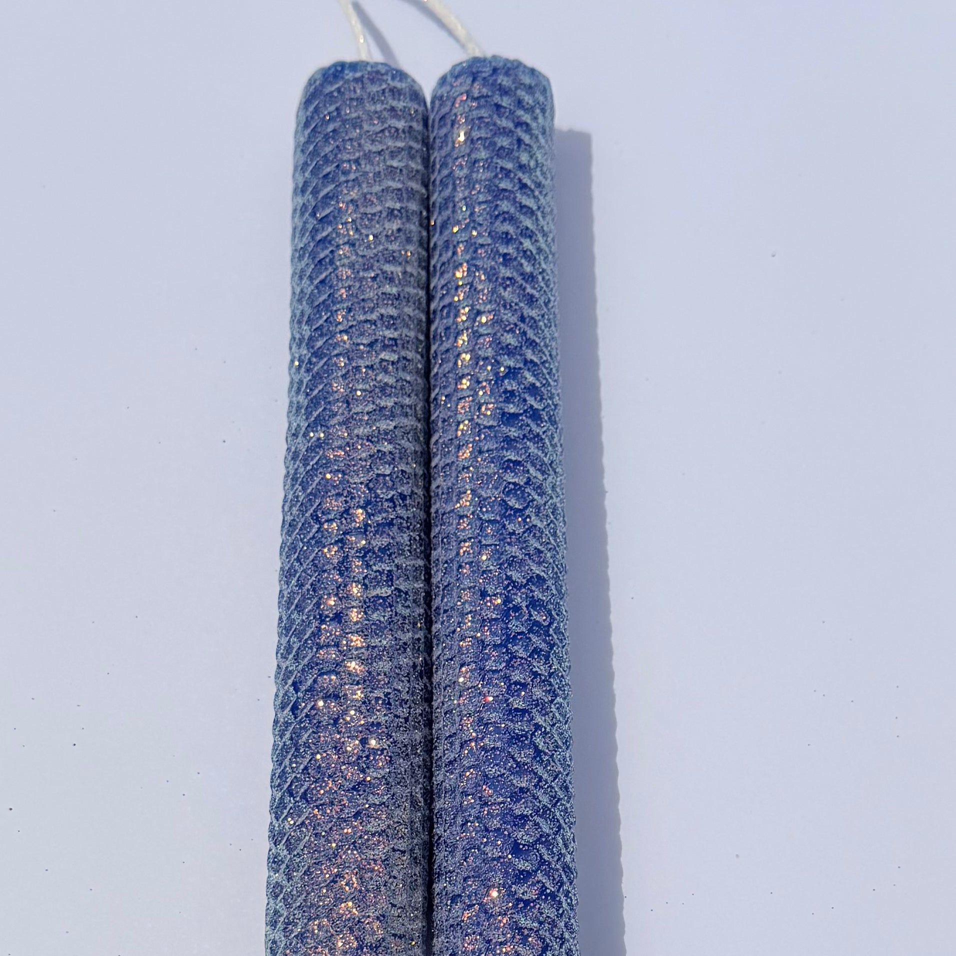 Our bright blue classic glitter candle dazzles with a vivid sapphire hue, wrapped in an opalescent glitter that glows with a golden undertone-infusing your space with a bold, energetic radiance and a sparkling, modern charm.