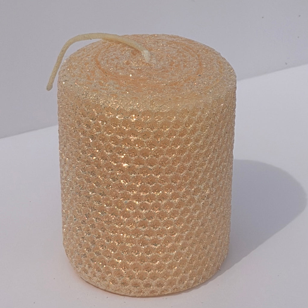 Our Champagne Limited Edition is a luminous celebration of elegance. Hand-rolled from pure beeswax, it radiates a creamy champagne hue with a whisper of pale pink. Delicately dusted in our classic iridescent glitter, it catches the light with a subtle gold undertone, making each candle a radiant, one-of-a-kind treasure.