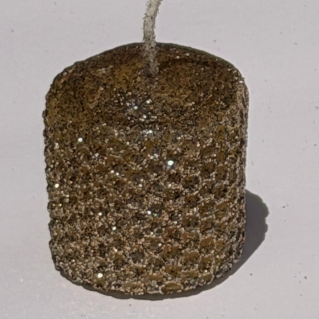 Illuminate your space with our Mercury Specialty Candle, hand-rolled from pure golden beeswax. This radiant candle is adorned with a delicate dusting of metallic glitter, a shimmering blend of silver and gold, allowing the warm glow of beeswax to peek through. Perfect for adding a touch of celestial elegance to any evening.