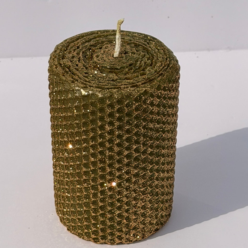 Embrace the essence of autumn with our Fall Brass Specialty Candle. Hand-rolled from olive green beeswax, this candle is crowned with a fine dusting of brass metallic glitter, letting the rich green glow softly beneath. Perfect for adding a subtle shimmer and a warm, seasonal charm to any event or gathering.