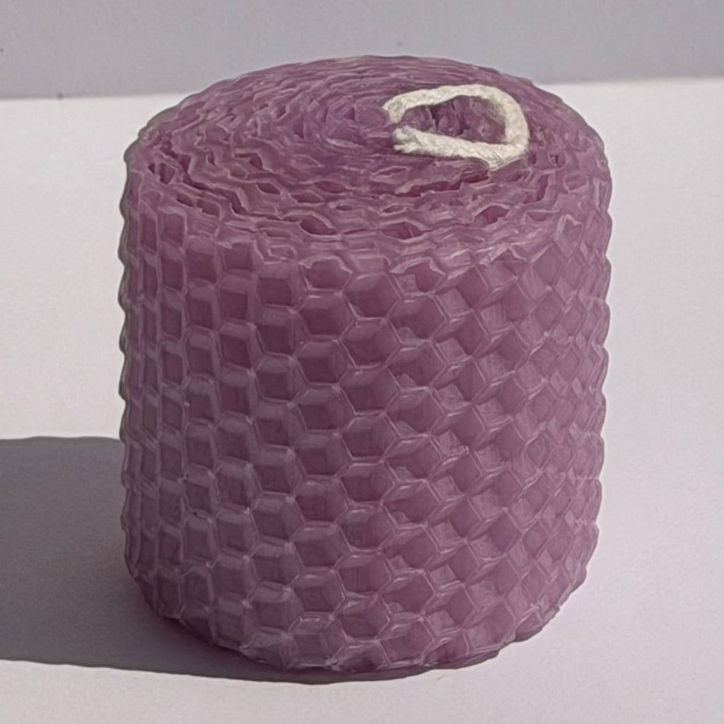 This candle is a soft lavender hue, reminiscent of an evening sky, bringing a gentle, calming elegance to any space.