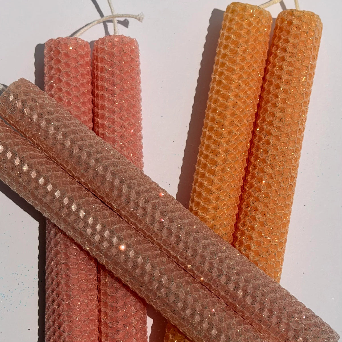 Close-up of textured brown and orange sticks on a white background